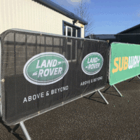 mesh crowd barrier cover example showing clients logo design for land rover and subway