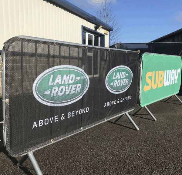 mesh crowd barrier cover example showing clients logo design for land rover and subway