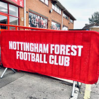 mesh crowd barrier jacket example showing clients logo design for nottingham forest football club